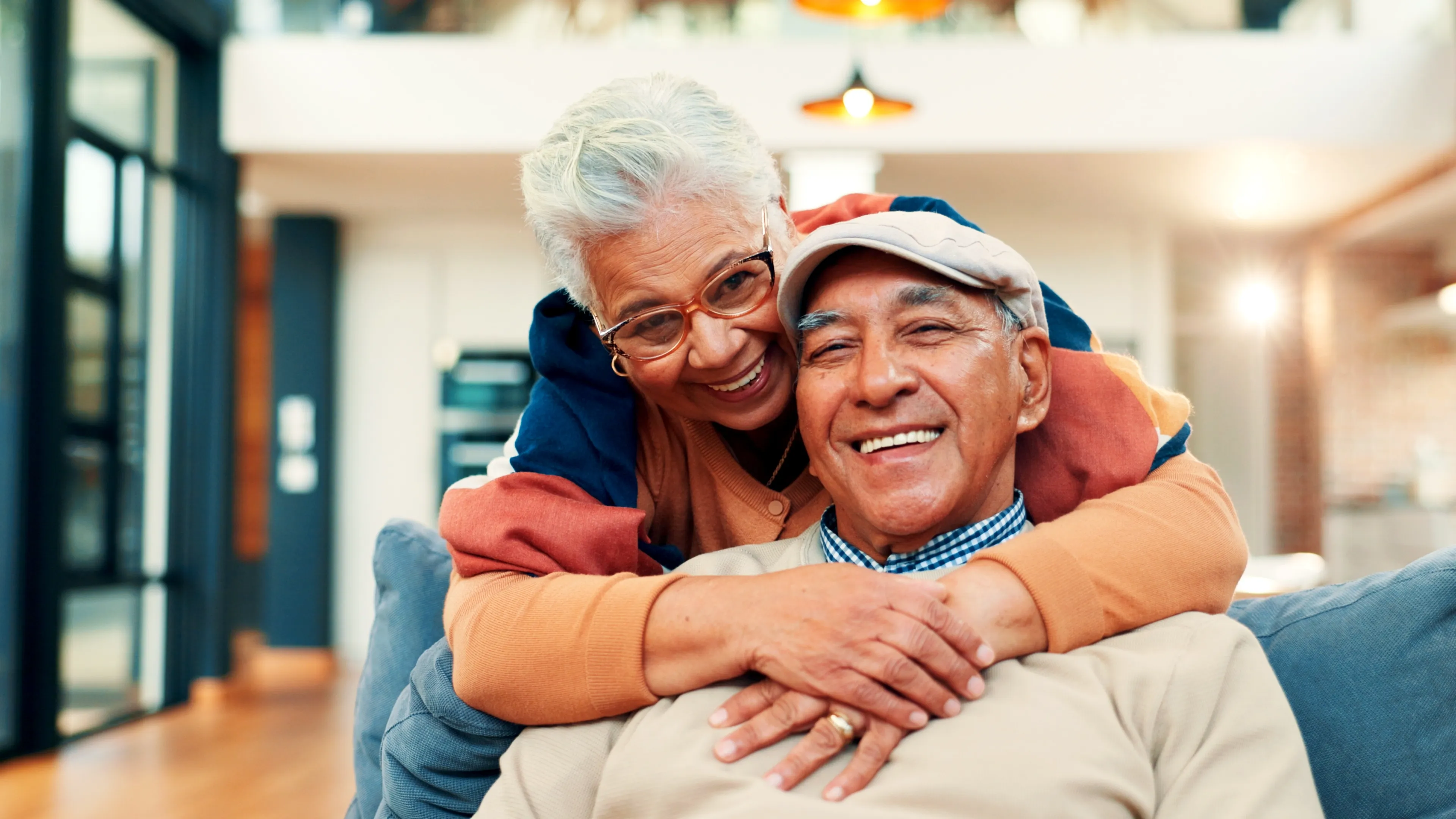 An older couple smiling outdoors