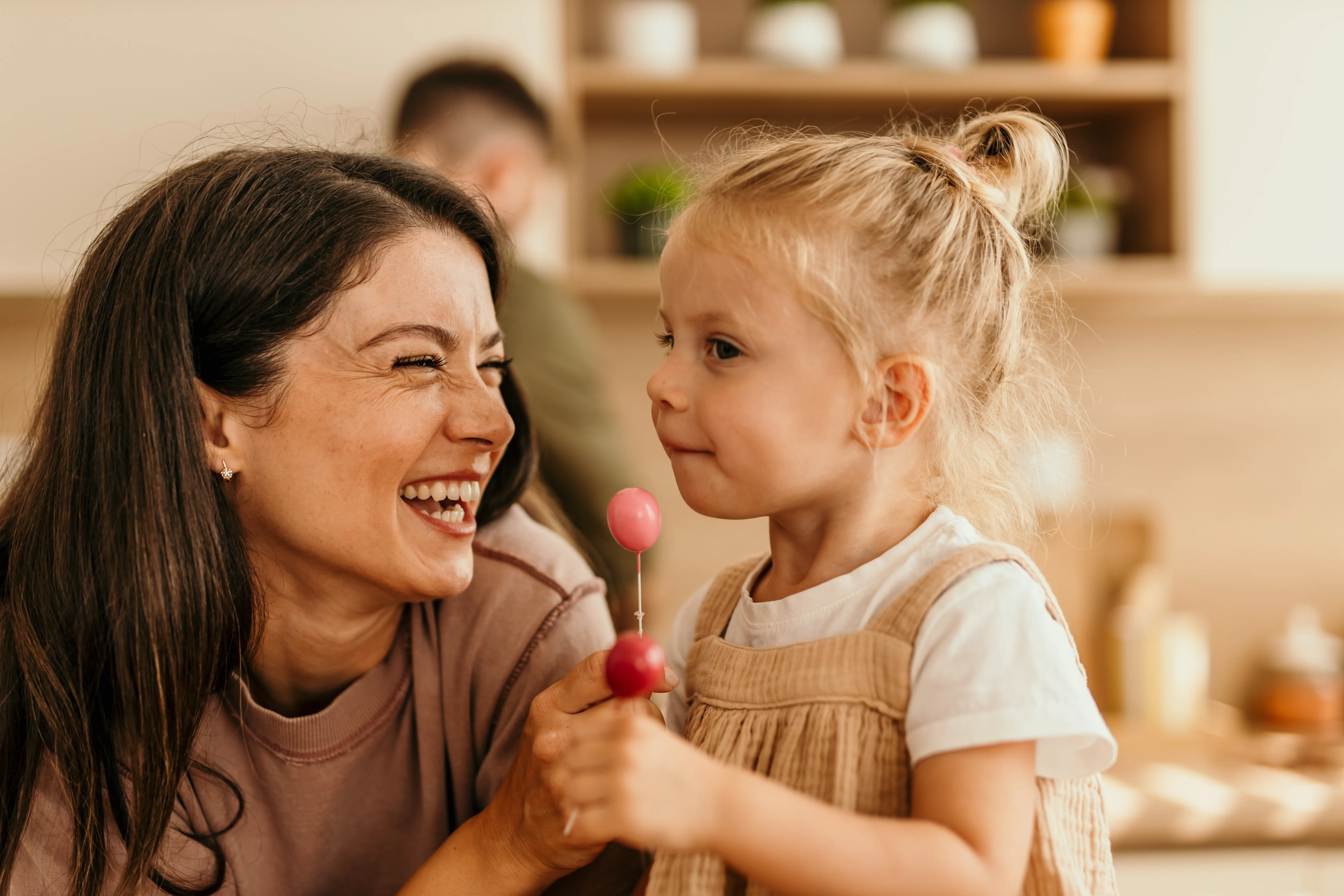 A parent and child smiling together
