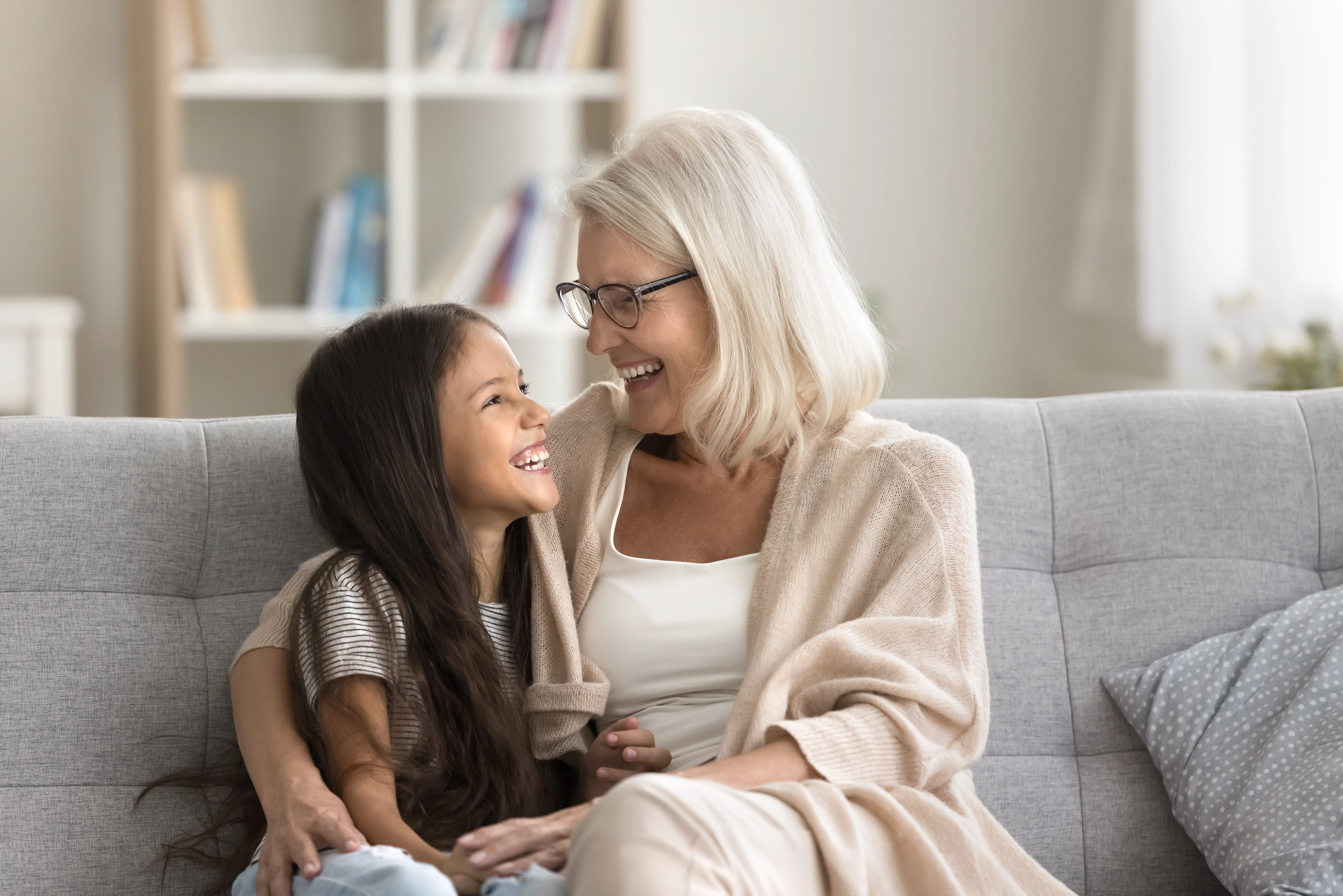 A grandmother and child relaxing in a living room